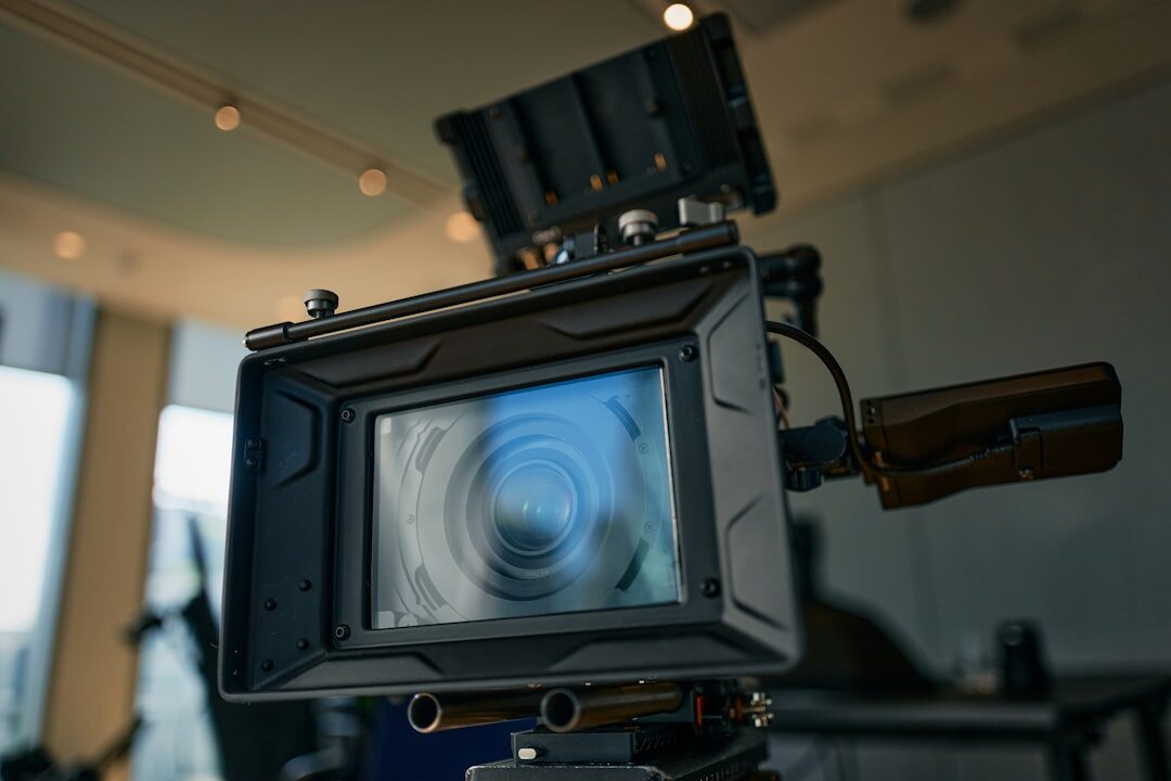 Professional video camera on tripod filming documentary in studio