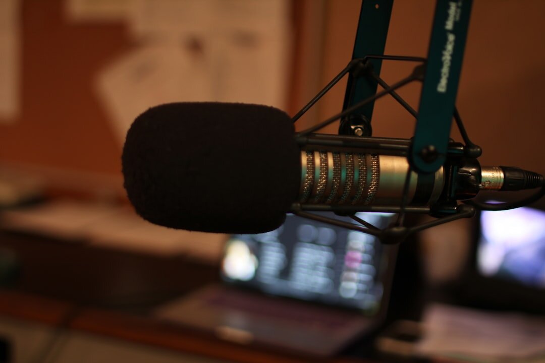Person speaking passionately into microphone in radio studio