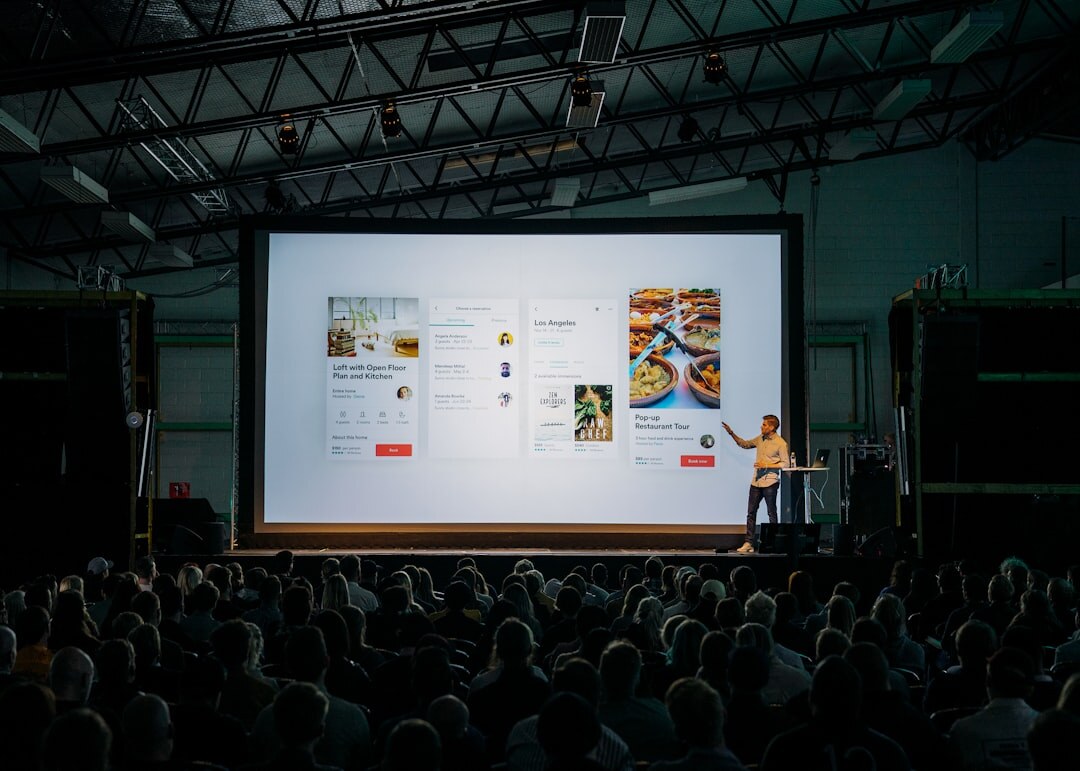 Professional conference speaker on modern stage with microphone
